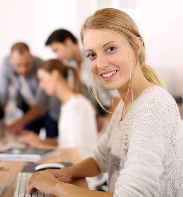 Lady at desk, happy after using Zetadocs Express document management software on Business Central