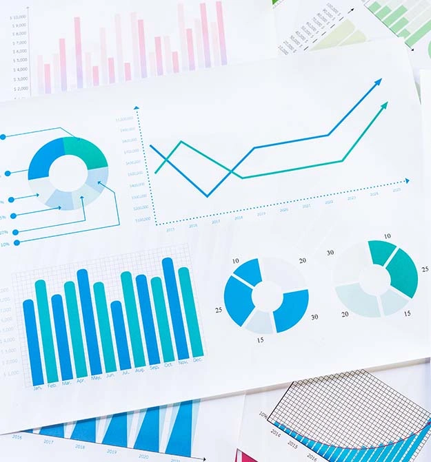 Pile of papers showing graphcs, charts, infographics