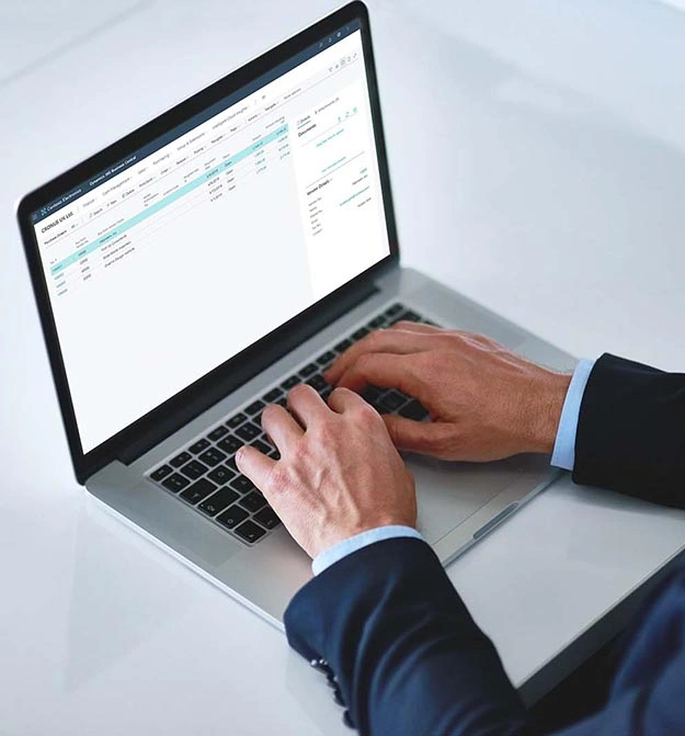 Male Using Zetadocs On Business Central On Laptop