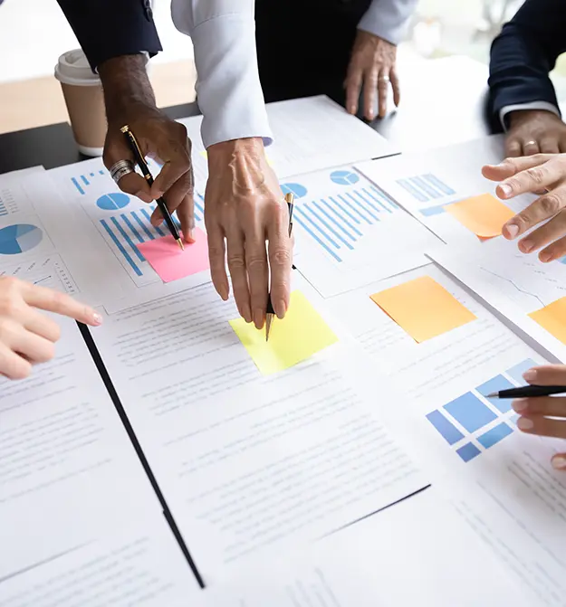 Business professionals collaborating on a project for the project expense page thumbnail